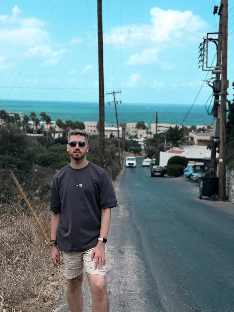 Martin Sidorov standing on a coastal street